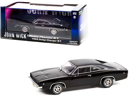 A 1/43 scale diecast model of a 1968 Dodge Charger R/T in black color, with the 'John Wick' box packaging.