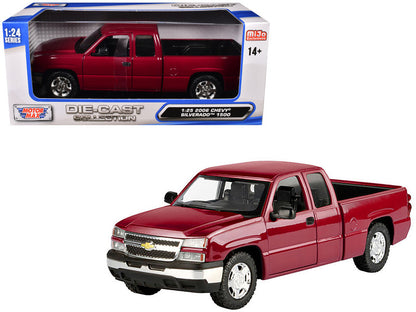 Red Chevrolet Silverado model truck in front of its packaging