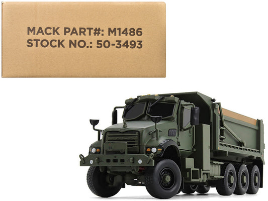 A 1/50 scale diecast model of a Mack Defense M917A3 Heavy Dump Truck in green color, with a box in the background indicating the product's packaging.