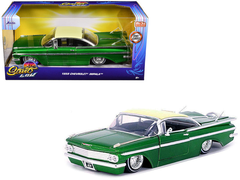 A 1/24 scale diecast model of a 1959 Chevrolet Impala Lowrider in green color with cream top, displayed in its packaging.