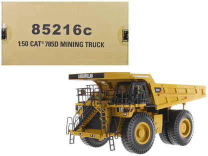 Model of a Caterpillar mining truck with packaging box displaying model number 85216c.