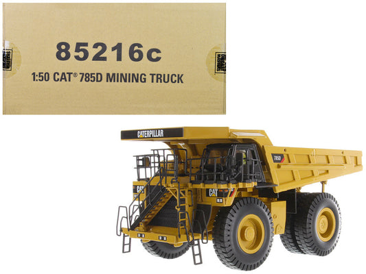 Model of a Caterpillar mining truck with packaging box displaying model number 85216c.