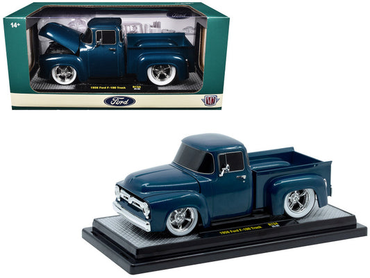 Model of a blue Ford truck on a display stand with packaging in the background