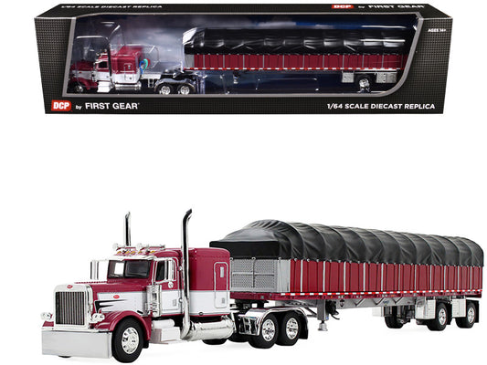 Model truck with red and white cab and black trailer in front of its packaging