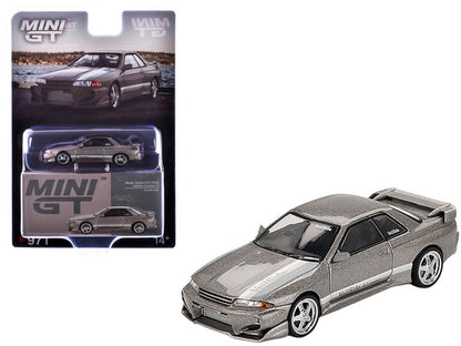 Silver die-cast car model with packaging displaying 'MINI GT' branding.