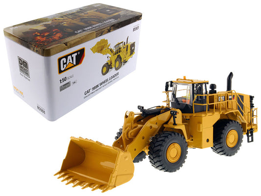 Yellow toy wheel loader with packaging in the background