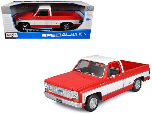 Model truck with red and white color scheme in front of its packaging