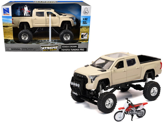 Toy truck with large wheels and a dirt bike in front of its packaging