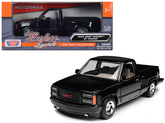 Black GMC truck model with Motormax packaging on a white background