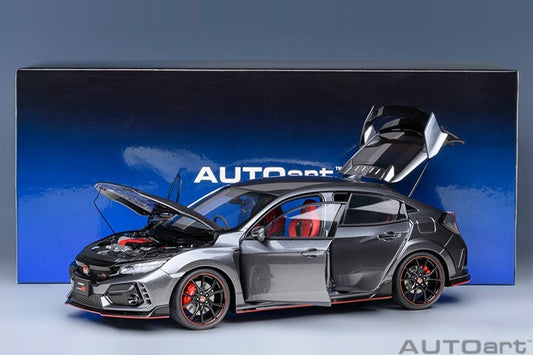 Model car with open doors and hood in front of an AUTOart branded box