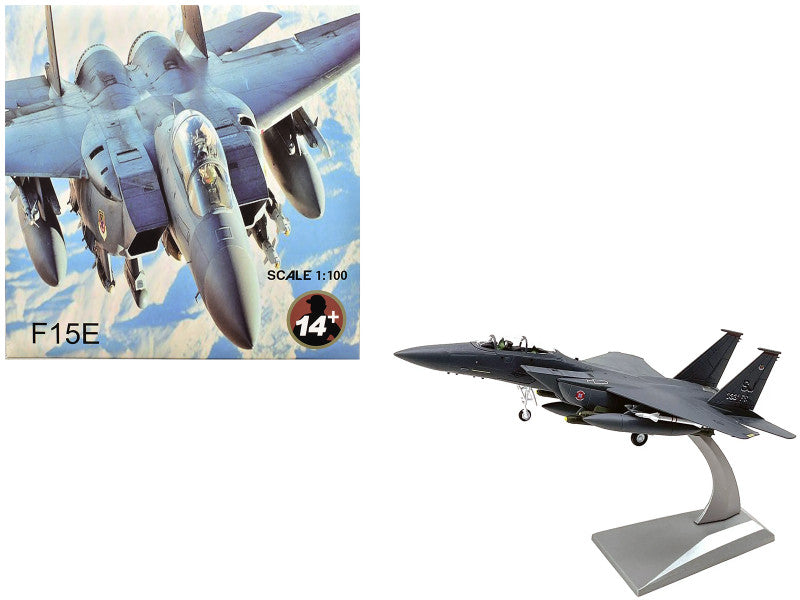 A McDonnell Douglas F-15E Strike Eagle aircraft model displayed next to its packaging which features the same aircraft in flight.