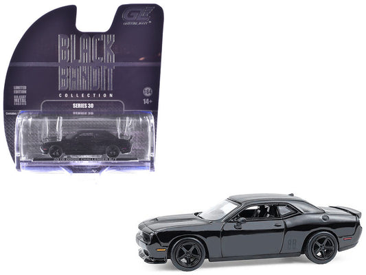 Black muscle car model with 'Black Collection' packaging on a white background