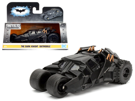 Toy Batmobile model with packaging on a white background