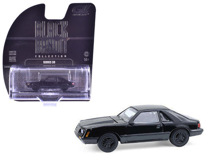 Black model car with packaging on a white background