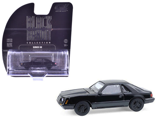 Black model car with packaging on a white background