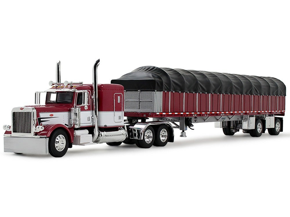 Model of a large truck with a red cab and black trailer on a white background