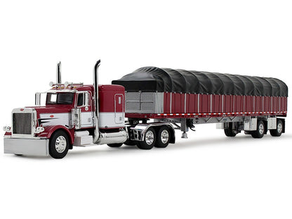 Model of a large truck with a red cab and black trailer on a white background
