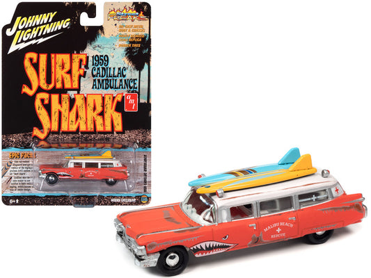 A 1:64 scale diecast model of a 1959 red Cadillac ambulance with surfboards on the roof, in a blister pack with 'Surf Shark' and 'Street Freaks' branding.