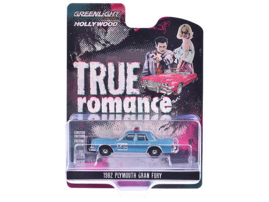 A diecast model of a 1982 Plymouth Gran Fury in blue color, representing the Detroit Police force from the movie 'True Romance'. The packaging features the movie poster art and the Greenlight Hollywood Series branding.