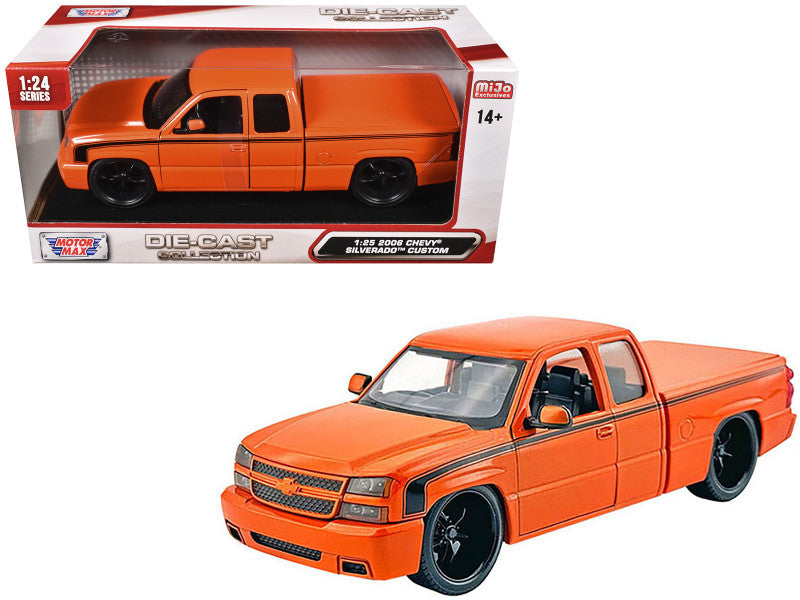 Orange model truck in front of its packaging