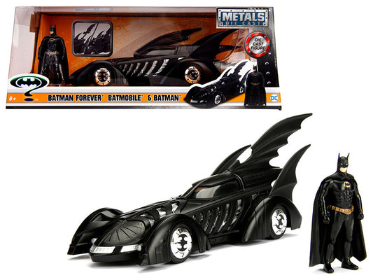 A 1/24 scale diecast model of the 1995 Batman Forever Batmobile with a diecast Batman figurine. The model is predominantly black with detailed exterior features, placed inside a clear plastic box.