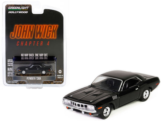 A 1/64 scale diecast model of a black Plymouth Barracuda from the movie 'John Wick: Chapter 4'. The model is in original packaging with 'Hollywood Series' branding.
