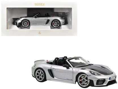 Model car of a Porsche Boxster Spyder in silver with Norev branding.