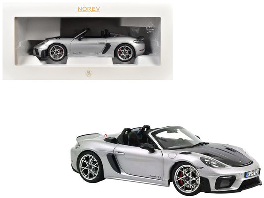 Model car of a Porsche Boxster Spyder in silver with Norev branding.