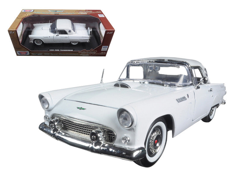 White model car with chrome details next to its packaging on a white background