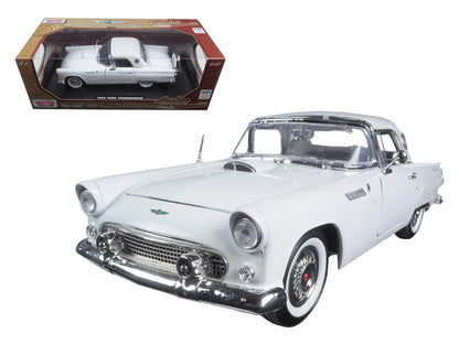 White model car with chrome details next to its packaging on a white background
