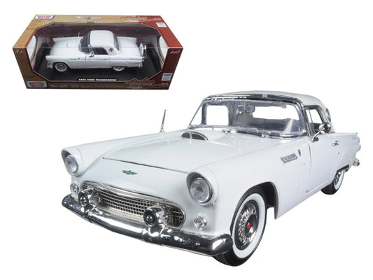 White model car with chrome details next to its packaging on a white background