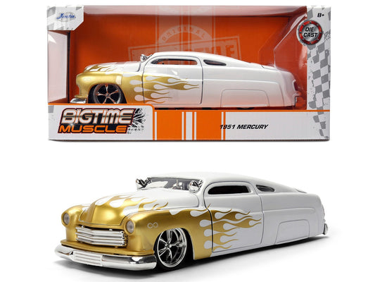 1951 Mercury model car with gold and white design in front of its packaging