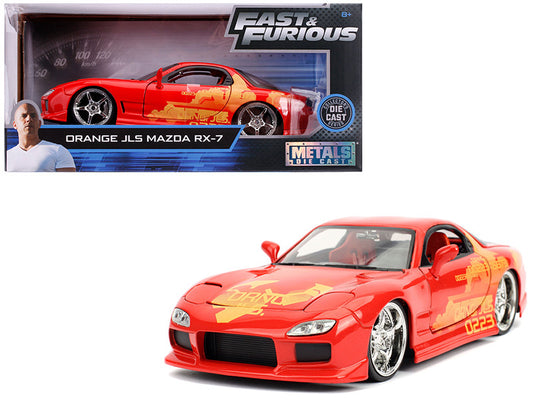 Red model car with yellow graphics in front of its packaging, featuring 'Fast & Furious' branding.