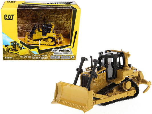 Toy bulldozer with packaging featuring the Caterpillar logo on a white background