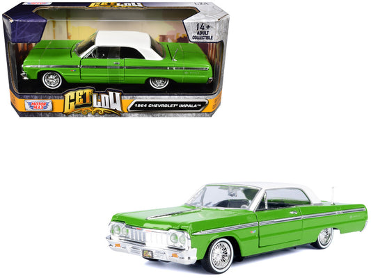 Green 1964 Chevrolet Impala model car in front of its packaging