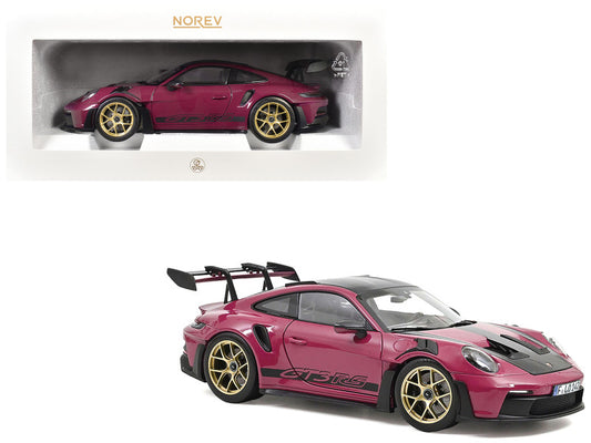 Pink sports car model with gold wheels on a white background