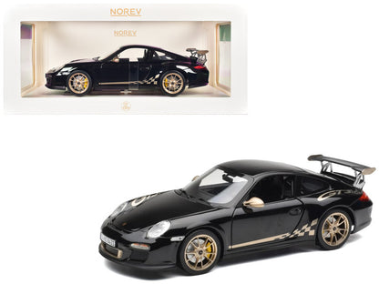 Black sports car model with gold accents on a white background, featuring the Norev brand.