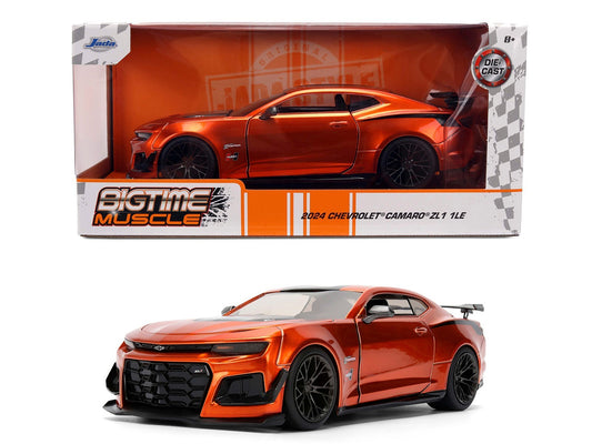Orange Chevrolet Camaro model car in front of its packaging
