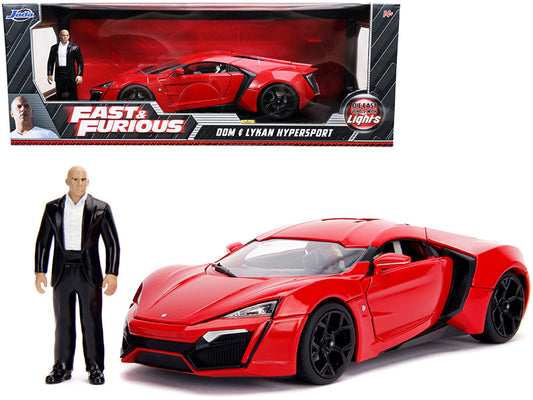 Red toy car with a figure in a suit next to its packaging, featuring 'Fast & Furious' branding.