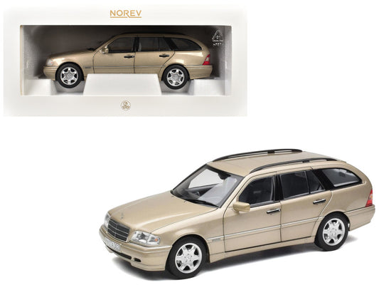Model car of a beige station wagon in a display case with Norev branding.