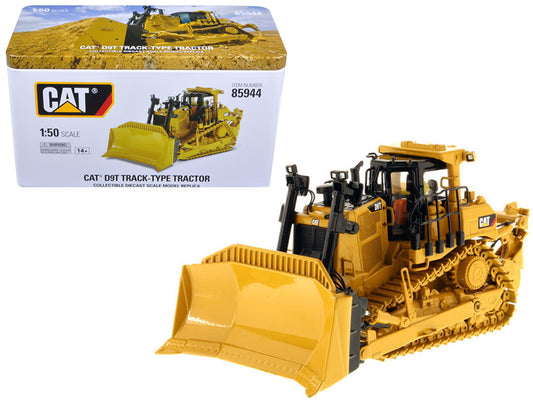 A 1:50 scale diecast model of a Cat Caterpillar D9T Track-Type Tractor in yellow color, showing the tractor with its blade raised, placed next to its packaging box.