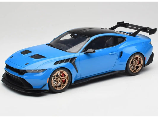 Blue sports car model with gold wheels on a gray background