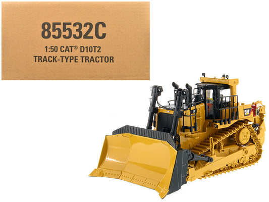 A 1:50 scale diecast model of a Caterpillar D10T2 Track Type Tractor in yellow, with the original packaging box in the background.