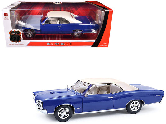 1967 Pontiac GTO model car in blue with white top, displayed both in and out of its packaging.